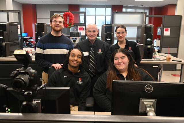 BuckID Card Services staff members standing behind service counter